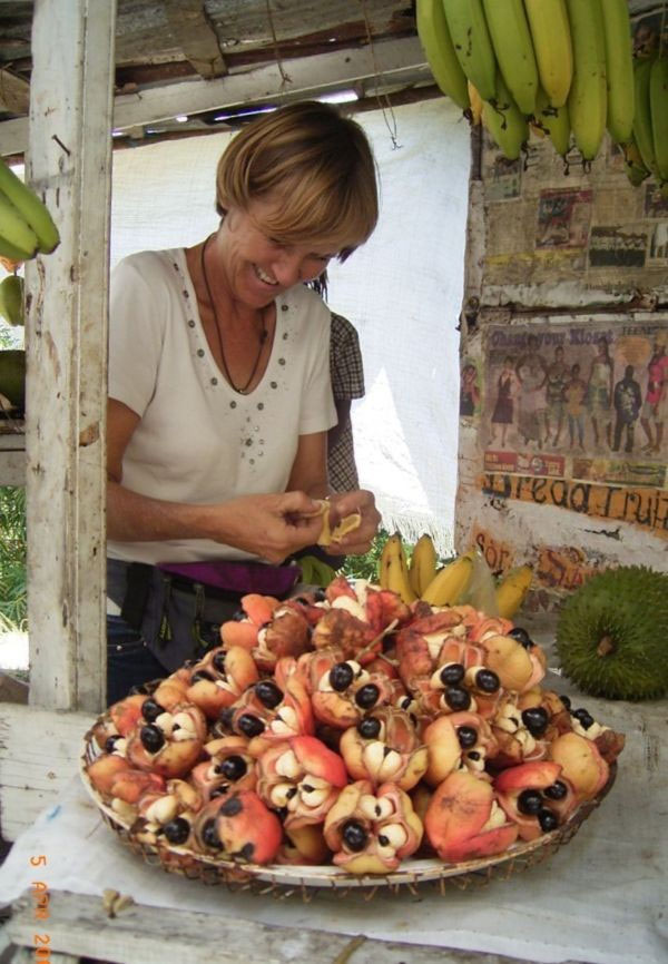 Margot showing fruit at a roadside stand