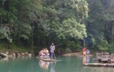 Small groups rafting on a green river