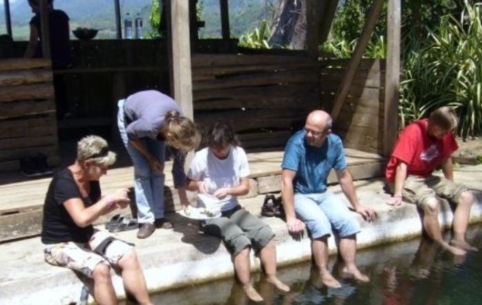 Guests sitting together beside a river